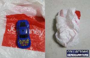 Wrapping action figures in plastic bags.